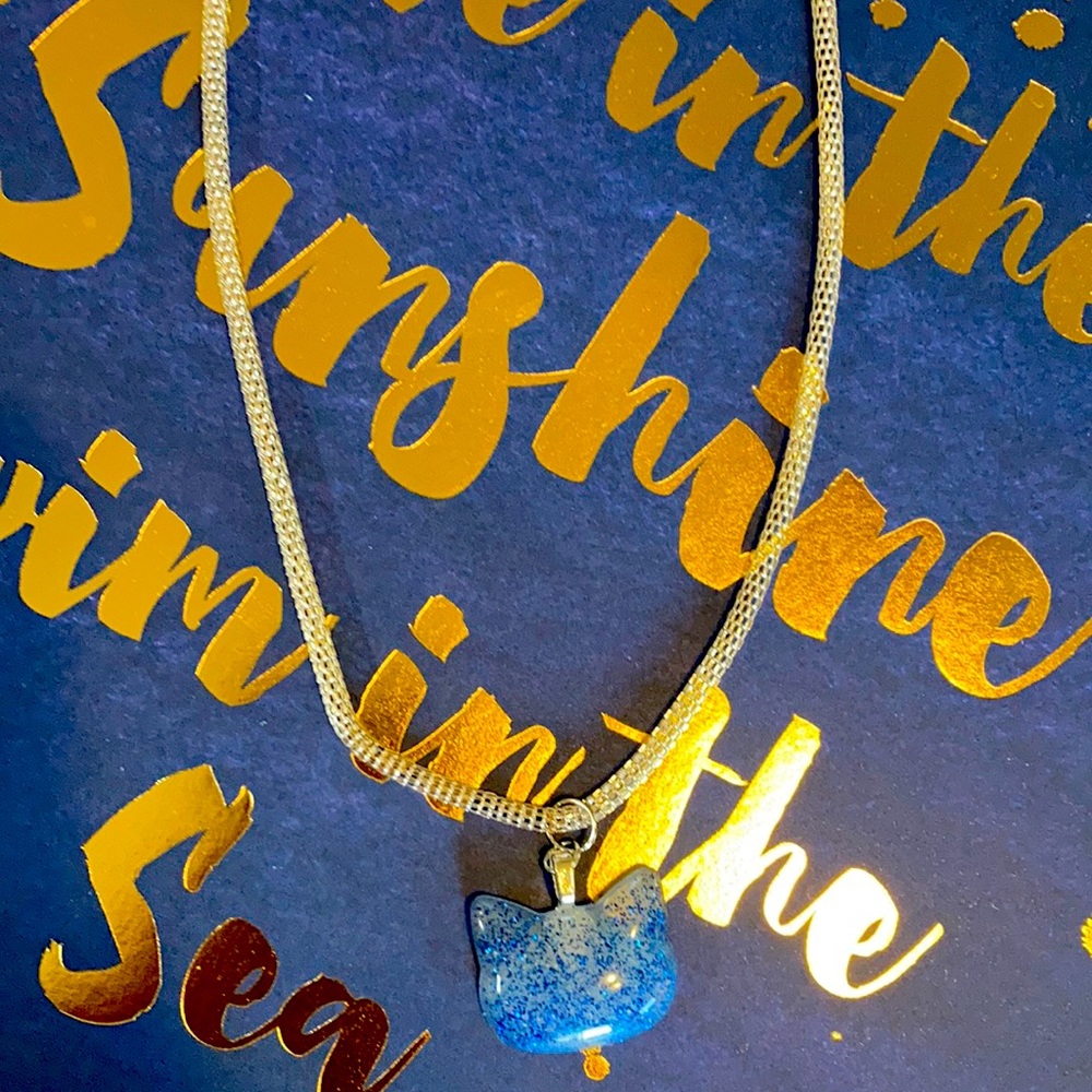 14” handmade silvertone necklace kitty pendant - opaque white with blue glitter.